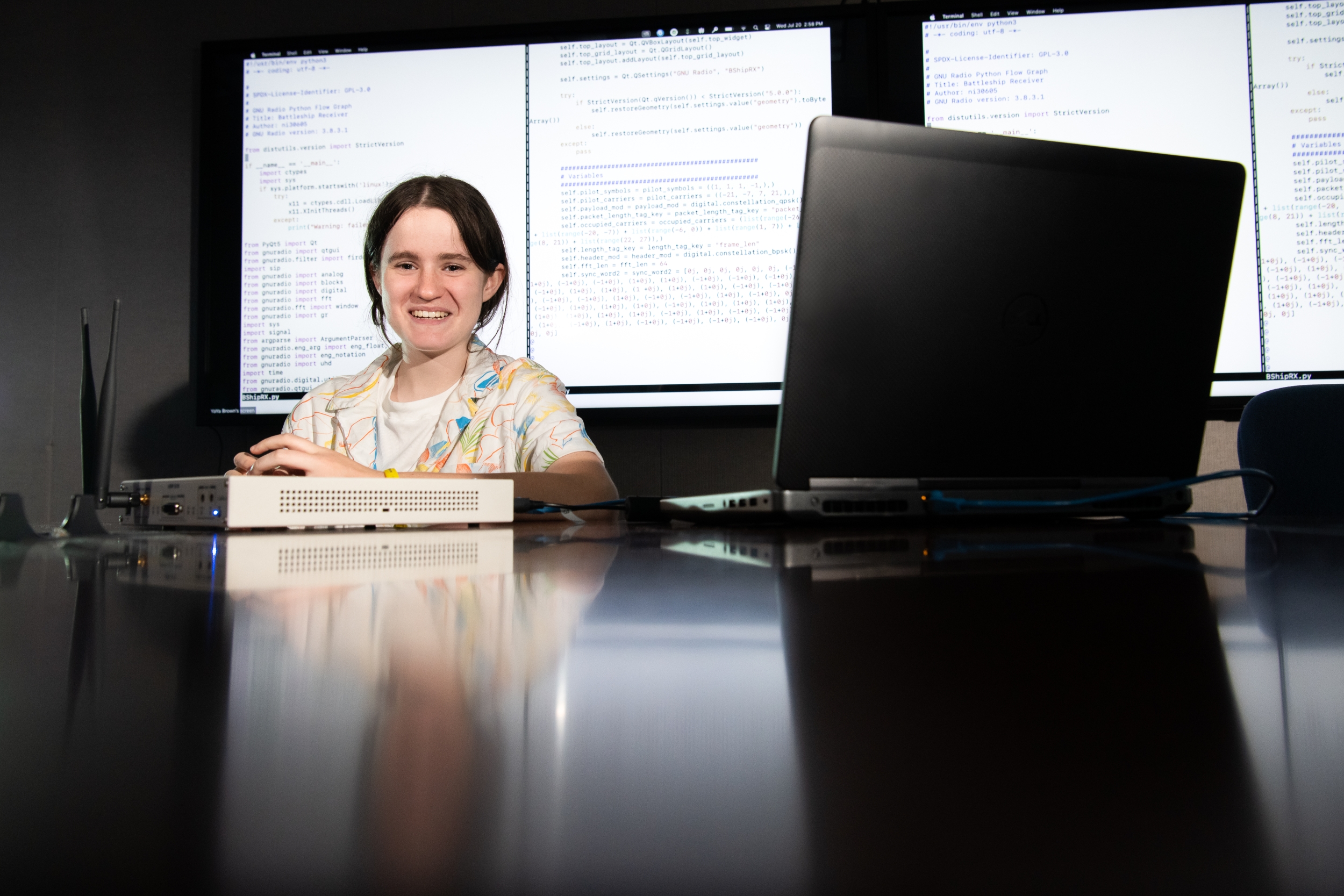 Mya Gordon at a computer, programming a battleship receiver. 