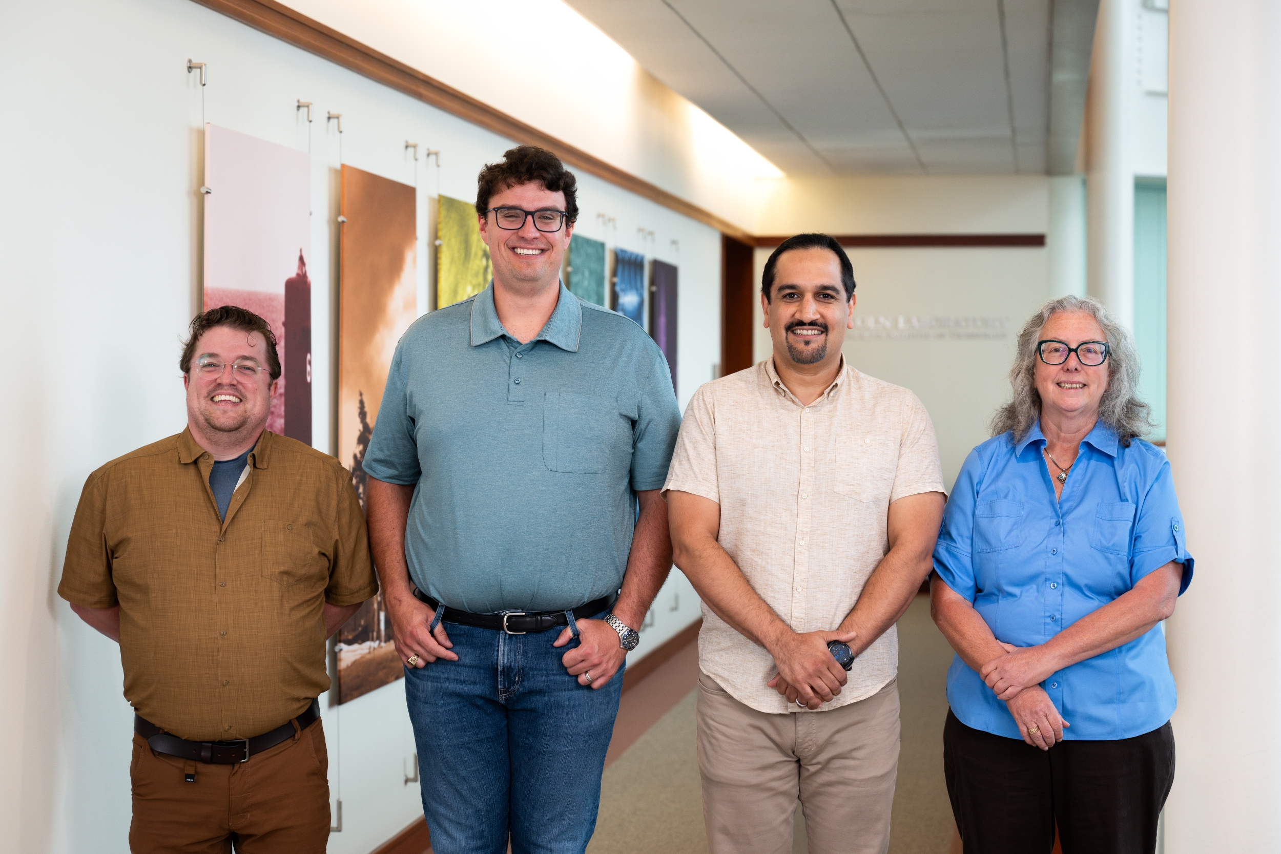 Four staff members smile for a group photo.