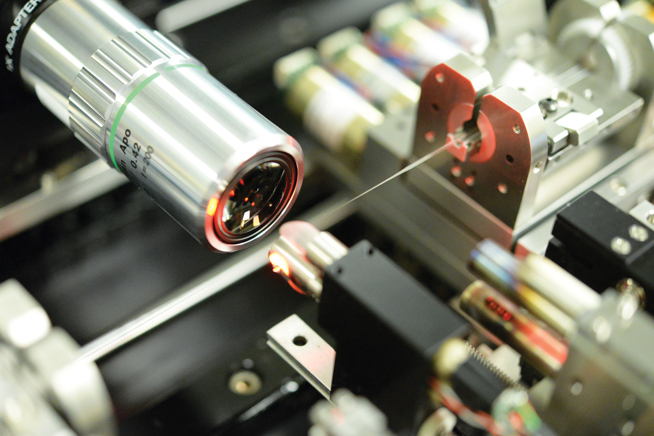 Photo of the photonic lantern, which is fabricated on a high-precision mechanical system. The tip of the photonic lantern is inspected with a microscope objective prior to the lantern's being spliced to a fiber.