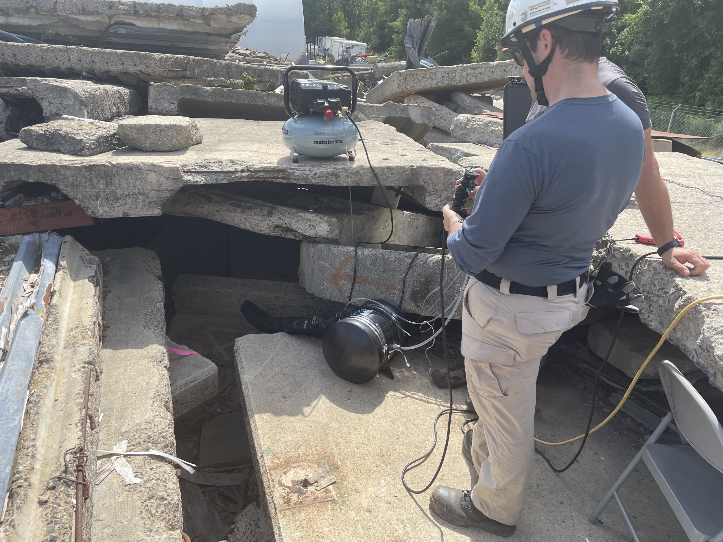 Chad Council tests the vine robot's capabilities outside in some concrete rubble. 