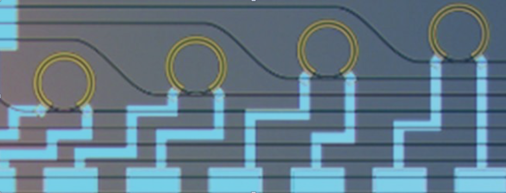 Optical microscope image of thermally tunable micro-ring resonators for 1550 nm light (waveguide loss ~0.13 dB/cm) fabricated using the silicon nitride platform.  