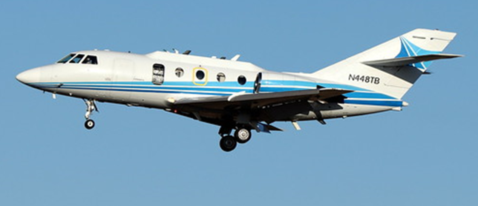 an airplane flying against a blue sky background