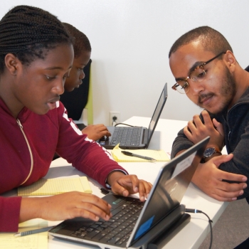 Eyassu Shimelis helps a student work through her code. Photo: Madelaine Millar