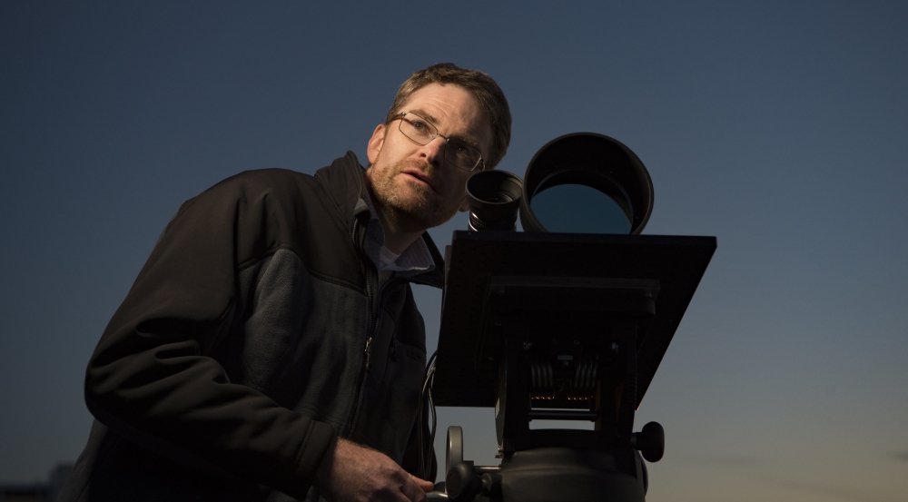 A member of the LASSOS development team with one of the LASSOS cameras. 