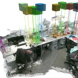 A cluttered desk scene as "seen" through robot's eyes show colored cubes as recognized objects.